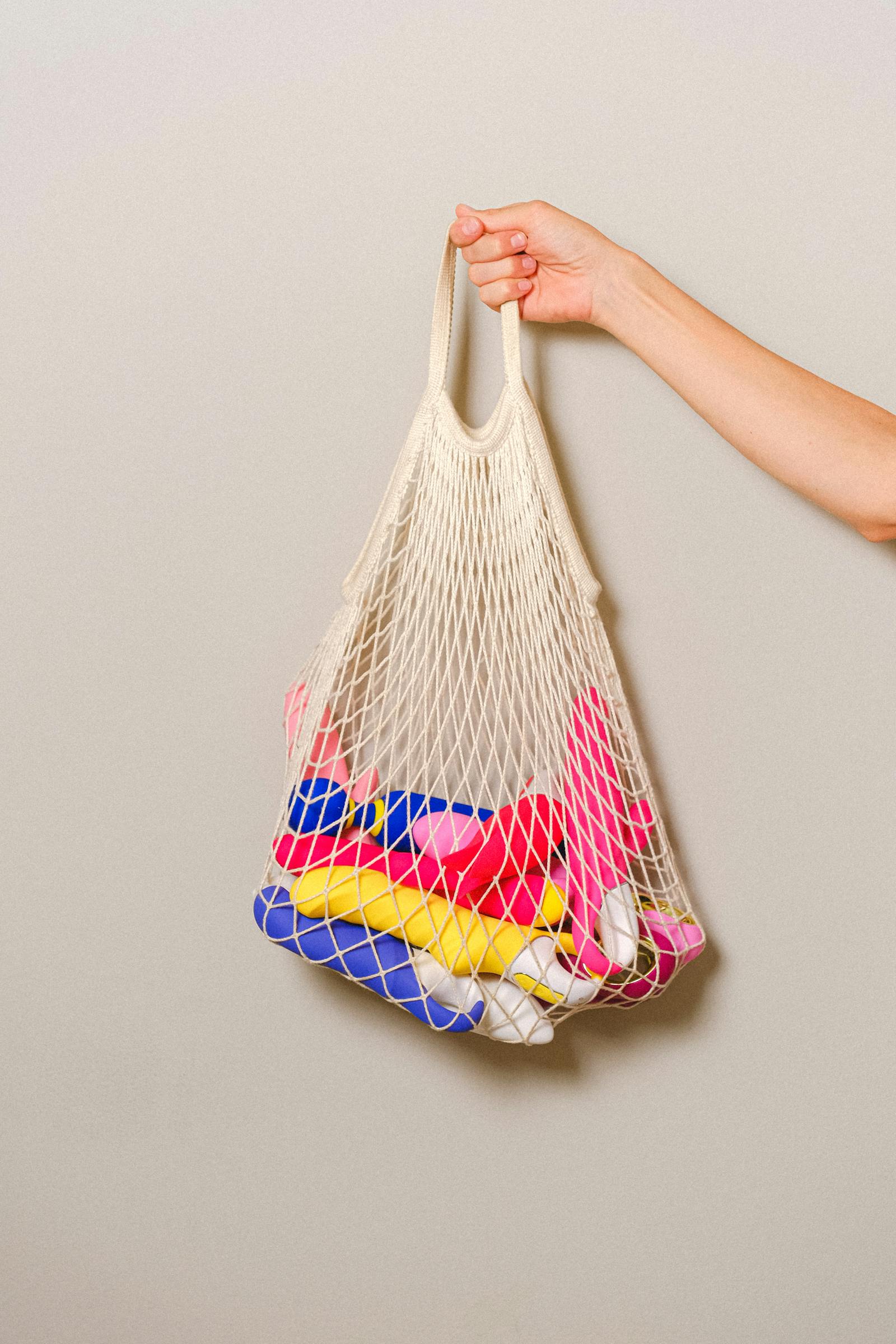 Adult toys arranged in a refined flat lay on a dark background