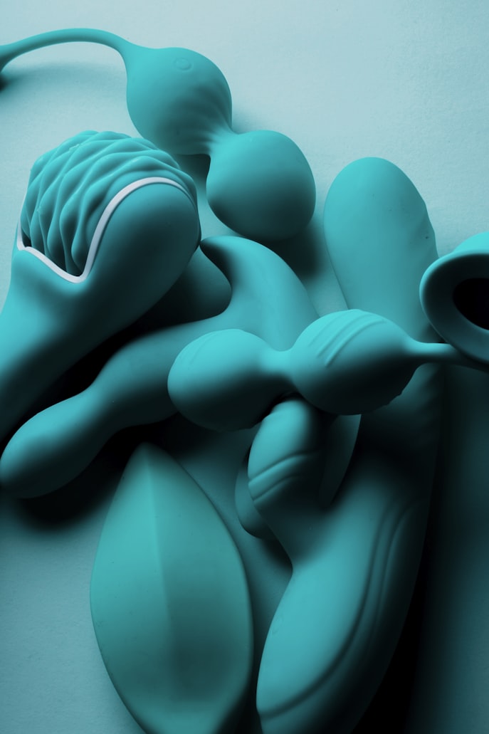 Adult toy product displayed on a warm studio surface